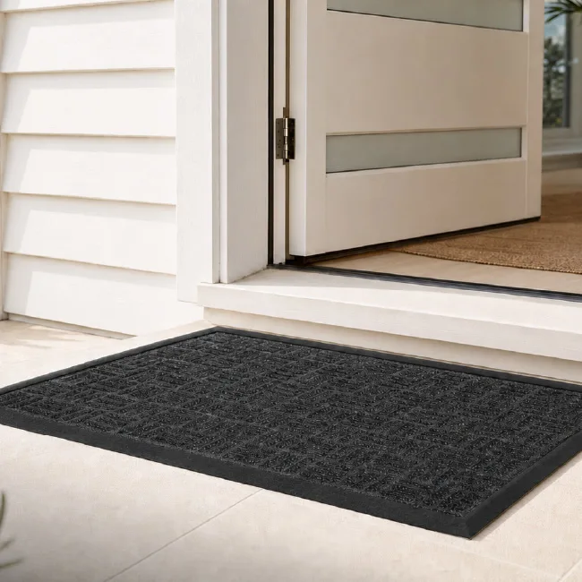 Clark Rubber Bantry Rubber Backed Mat at the front entrance of a coastal holiday home. Bantry Rubber Backed Mat outside a holiday rental helping reduce dirt indoors.