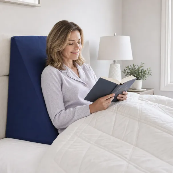 Person comfortably reading in bed with a foam-supported backrest setup.