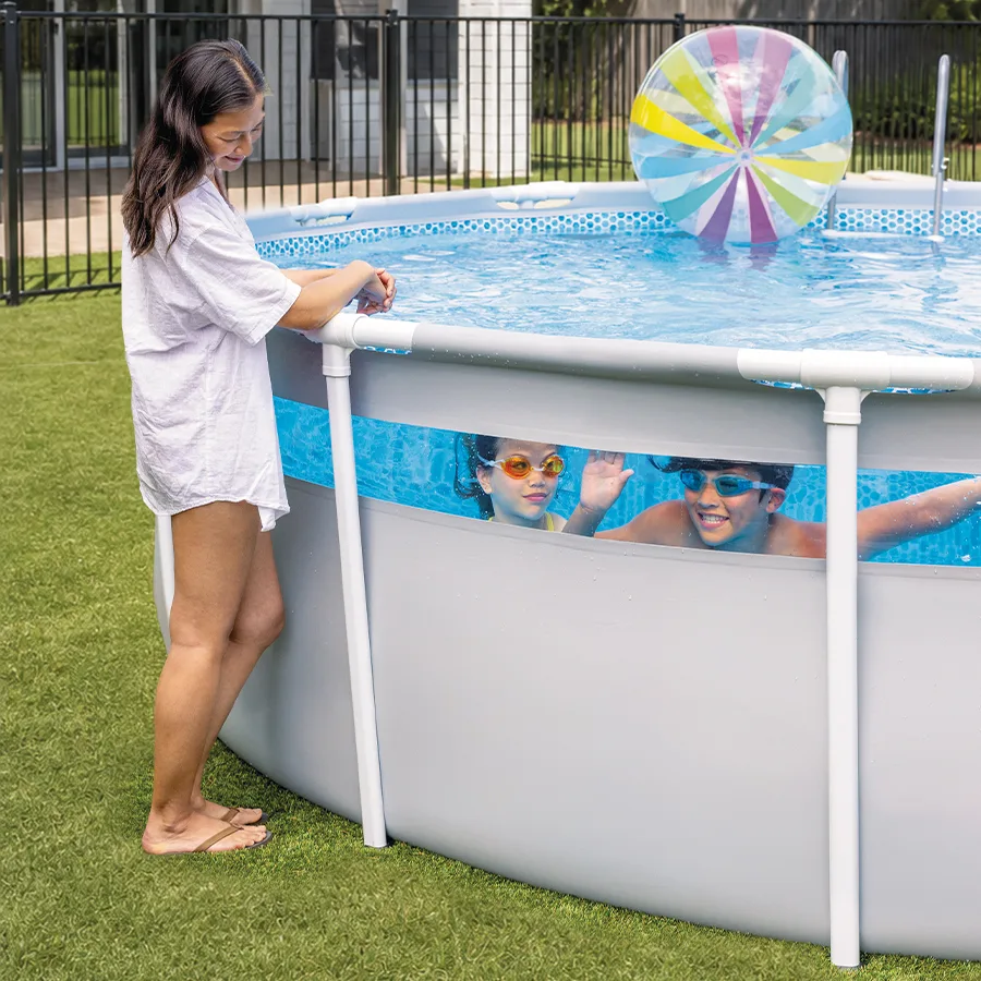 Family backyard with a portable pool set up for summer entertaining.