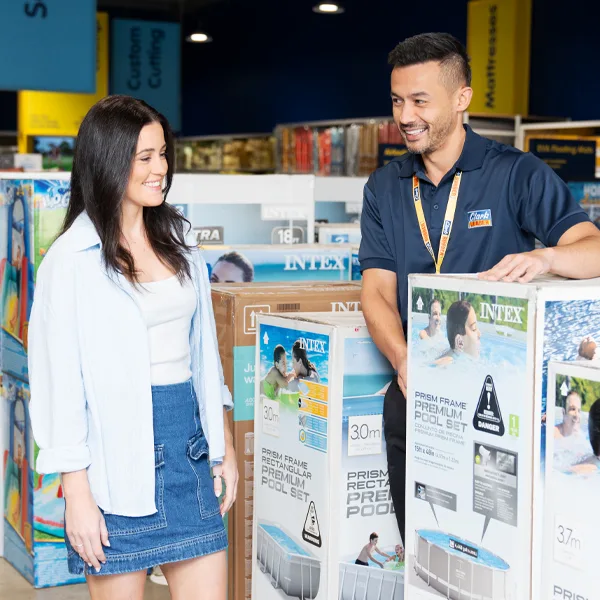 Customer speaking with a Clark Rubber expert in store for portable pool advice. 