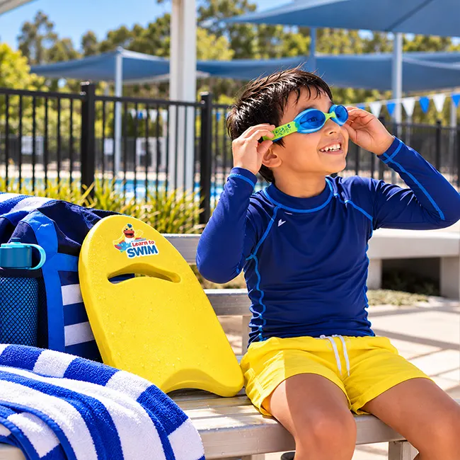 Child with suitable learn-to-swim gear before a swimming lesson