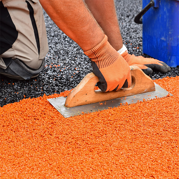 Wet pour recycled rubber surface installed in an outdoor pathway area